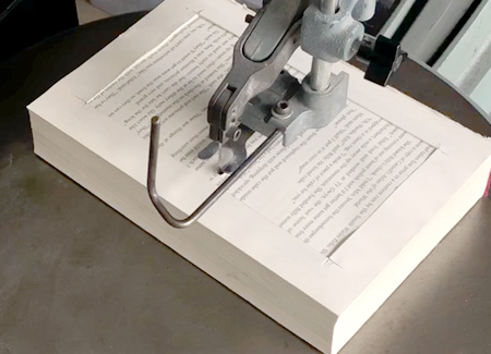 The book, loaded into the saw